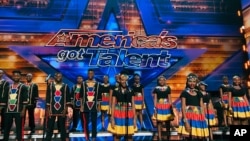 In this handout photo provided by Ndlovu Youth Choir and taken March 2019, chorus members stand on stage during a taping of the U.S. television show America Got Talent in Los Angeles. 