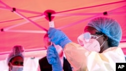 A health worker prepares to administer a vial of a vaccine against the Sudan strain of Ebola, during a trial at Mulago Referral Hospital in Kampala, Uganda, Feb. 3, 2025.