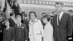 FILE - Then-Attorney General Robert F. Kennedy, right, wife Ethel Kennedy, and children, from left, Bobby, Joseph, and Kathleen, second right, pose at Kennedy International Airport in New York, July 1, 1964, shortly after they returned from a trip to West Germany and Poland.