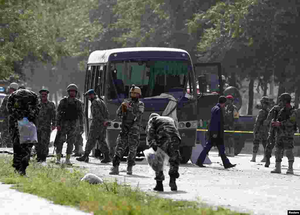 Officials investigate at the site of a suicide attack in Kabul, July 2, 2014. 