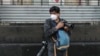 FILE - AFP photographer Alfredo Estrella wears a face mask as he works during the coronavirus pandemic, in Mexico City, Mexico, April 8, 2020. 