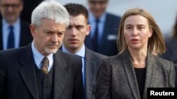 European Union Foreign Policy Chief Federica Mogherini (R) and Deputy Head of the Delegation of the European Union to Bosnia and Herzegovina Renzo Daviddi leave the Parliament building in Sarajevo, Feb. 23, 2015.