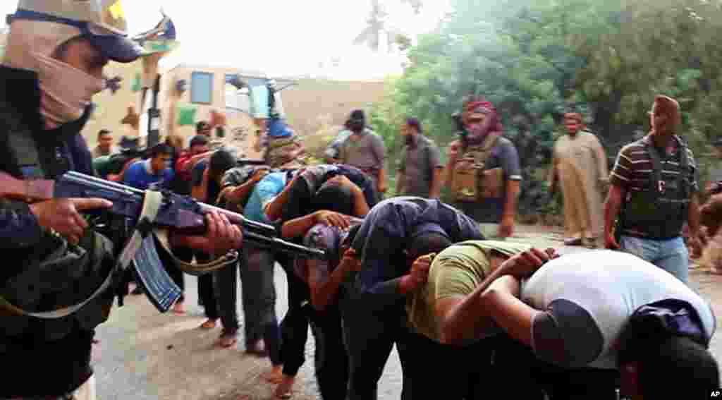 This image posted on a militant website on June 14, 2014 appears to show militants from the Islamic State of Iraq and the Levant moving&nbsp;captured Iraqi soldiers after taking over a base near Tikrit, Iraq.