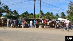 FILE - Residents visit a market in Macomia, northern Mozambique, June 11, 2018. Some experts believe IS has already set its sights on Mozambique, particularly its northern region, because of the economic disparity that, in part, allows radical Islamist ideology to flourish.