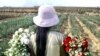 Peruvian Gisela Huamani, 11, carries flowers during a harvest at a field in a shantytown in Lima, May 26, 2005.
