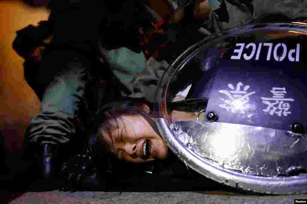 An anti-extradition bill protester is detained by riot police during a protest outside Mong Kok police station, in Hong Kong, China, Sept. 2, 2019.