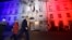 U.S. Secretary of State John Kerry (C), next to U.S. ambassador to France Jane D. Hartley, leaves after delivering a speech at the U.S. embassy in Paris illuminated with the colors of the French national flag, Nov. 16, 2015.
