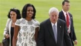US's first lady Michelle Obama and U.S. Ambassador Louis B. Susman arrive at Buckingham Palace in London for a reception hosted by Queen Elizabeth II for the heads of state and governments prior to them attending the opening ceremony of London 2012 Olympi