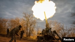 FILE: Ukrainian servicemen fire a 2S7 Pion self-propelled gun at a position on a frontline in Kherson region. Taken November 9, 2022