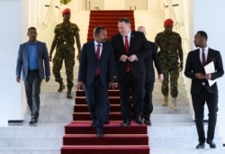 US Secretary of State Mike Pompeo, center right, walks with Ethiopian Prime Minister Abiy Ahmed at the Prime Minister's office in Addis Ababa, after a meeting, Feb. 18, 2020.
