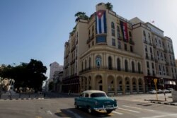 A Cuban flag hangs on Parque Central Hotel in Havana, Cuba, early on July 12, 2021, the day after protests against food shortages and high prices amid the coronavirus crisis.