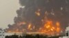 TOPSHOT - A handout picture obtained from Yemen's Huthi Ansarullah Media Center show a huge column of fire erupting following reported strikes in the Yemeni rebel-held port city of Hodeida opn July 20, 2024.