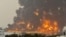 TOPSHOT - A handout picture obtained from Yemen's Huthi Ansarullah Media Center show a huge column of fire erupting following reported strikes in the Yemeni rebel-held port city of Hodeida opn July 20, 2024.