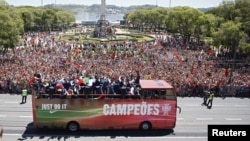 Portugal's winning EURO 2016 team ride in an open bus on their return to Lisbon, Portugal, July 11, 2016. 