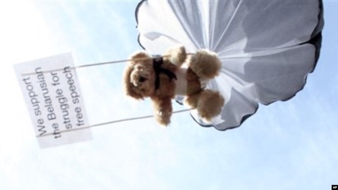 Teddy bear hangs on parachute during protest training for Belarusian airspace intrusion by Swedish human rights activist, Stockholm, July 2012.