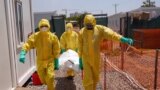 FILE - Members of medical team carry the body of a deceased COVID patient on a stretcher at a Ministry of Health Infectious Disease Unit in Juba, South Sudan, May 28, 2020. 