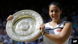 Marion Bartoli dari Perancis dengan trofi Wimbledon (6/7). (AP/Anja Niedringhaus)