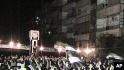 Demonstrators gather during a protest against Syria's President Bashar al-Assad in Homs, February 10, 2012.
