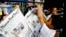 A Cambodian boy hangs up copies of the English-language newspaper, Phnom Penh Post, at the newsstand in Phnom Penh, file photo. 