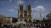 FILE - Scaffolding is being removed around the spire of Notre Dame de Paris cathedral, showing the rooster and the cross, in Paris, Feb. 17, 2024. 