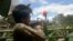 This screengrab from a video provided to AFPTV from an anonymous source and taken on May 23, 2021, shows a People's Defense Force (PDF) fighter shooting during clashes with Myanmar security forces.