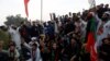 People chant slogans as they block main highway during a protest to condemn the shooting incident on a long march held by Pakistan's former Prime Minister Imran Khan, in Wazirabad, Pakistan Nov. 4, 2022. 