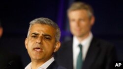 Sadiq Khan, Labour Party candidate, speaks in front of Zac Goldsmith, Conservative Party candidate, after winning the London mayoral elections, at City Hall, London, May 7, 2016. 