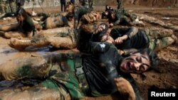 Members of Kurdish Peshmerga Special Forces demonstrate their skills during their graduation ceremony at a military camp in Soran district, in Erbil province, Iraq.