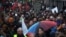 People march under rain during a demonstration in support of migrant people seeking to enter Europe, in Brussels, Saturday, Jan. 12, 2019.