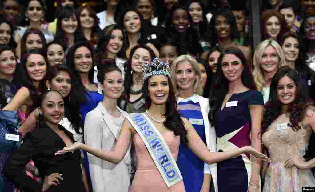 &nbsp;Megan Young of the Philippines, Miss World 2013, poses in the middle of 2014 event finalists during a publicity launch in central London. The final of the 2014 edition of the Miss World pageant will take place in London on December 14.