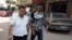 Once physically female, Mohammad Alaam (L) and his friend stroll through a Cairo suburb, June 13, 2016. (H. Elrasam/VOA)