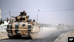 Turkish army tanks and armored personnel carriers move toward the Syrian border, in Karkamis, Turkey, Aug. 25, 2016. Ankara on Saturday launched a second incursion into Syria in as many weeks.