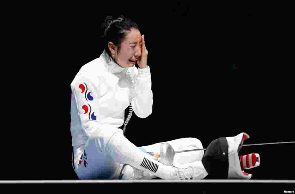 South Korea&#39;s Shin A Lam reacts after being defeated by Germany&#39;s Britta Heidemann during their women&#39;s epee individual semifinal fencing competition at the ExCel venue.