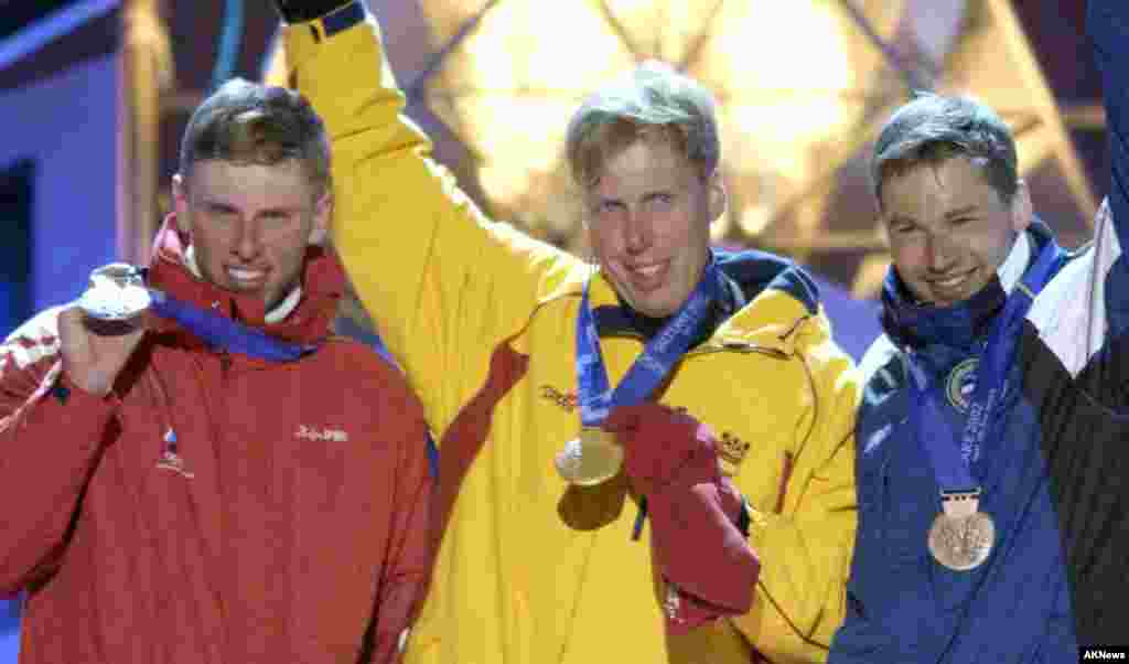 Medalist in the men's 50-kilometer classic cross-country event at the Winter Olympics celebrate at the awards ceremony in downtown Salt Lake City, Utah, Saturday, Feb. 23, 2002. From left are: Mikhail Ivanon of Russia, silver medal; Johann Muehlegg of Sp