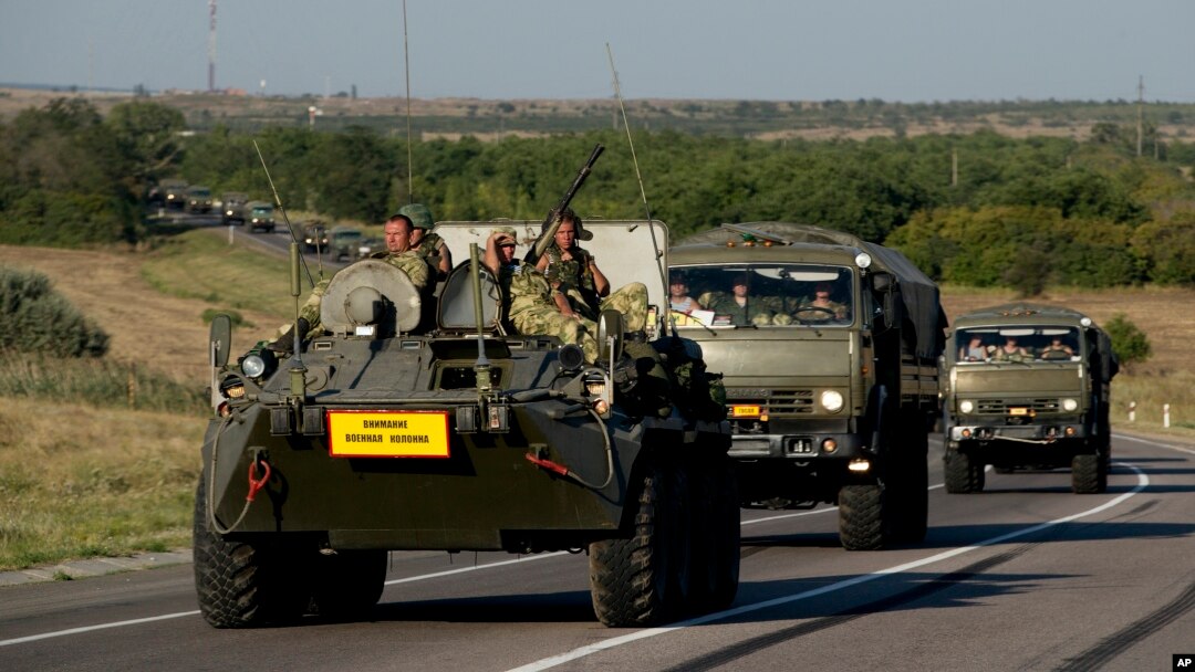 Russian military vehicles maneuver on a road 15 kilometers (9 miles) from the Ukrainian border in the Rostov-on-Don region, Russia, Aug. 15, 2014.