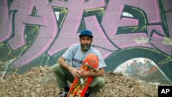 Skateboarder Dallas Oberholzer, 46, poses for a photo at the Germiston Lake Skateboard Park, near Johannesburg, July 3, 2021.