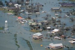 Buildings and homes are flooded in the aftermath of Hurricane Laura on Aug. 27, 2020, near Lake Charles, La.