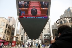 Giant screen shows Chinese President Xi Jinping attending the closing session of the National People's Congress (NPC) at the Great Hall of the People, in Beijing.