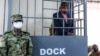 FILE - Ugandan opposition leader and four-time presidential candidate Kizza Besigye stands in the dock at Makindye Martial Court in Kampala, Uganda, Nov. 20. 2024.