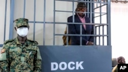 FILE - Ugandan opposition leader and four-time presidential candidate Kizza Besigye stands in the dock at Makindye Martial Court in Kampala, Uganda, Nov. 20. 2024.