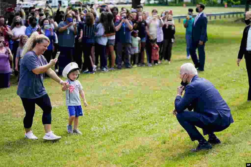 President Joe Biden stops outside at York High School to greet a child and his mother in Yorktown, Virginia.
