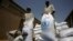 FILE - Sacs of sorghum are stored following the delivery of nearly 50,000 tonnes of US food aid bound for areas of Sudan affected by conflict, on May 26, 2015. in Port Sudan. T