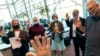 FILE - Election challengers are sworn in before observing the counting of ballots on Election Day at City Hall in Warren, Michigan, Nov. 3, 2020.