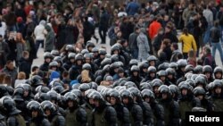 FILE - Law enforcement officers gather as they block opposition supporters in Moscow, Russia, March 26, 2017. 