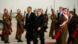 U.S. President Barack Obama walks with Jordanian Foreign Minister Nasser Judeh, right, upon his arrival at Queen Alia International Airport in Amman, Jordan, March 22, 2013. 