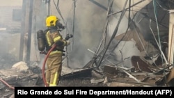 Handout picture released by Rio Grande do Sul Fire Department showing firefighters working on the site of a plane crash in Gramado, Rio Grande do Sul, Brazil, Dec. 22, 2024.