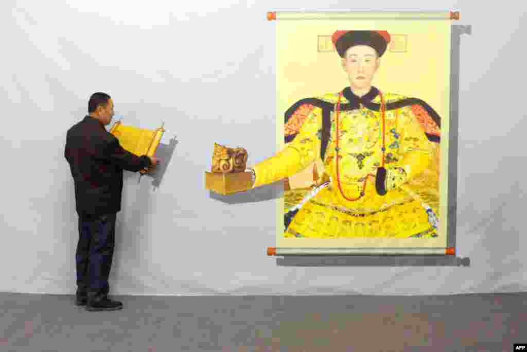 A man interacts with a 3D painting during a Magic Art Special exhibition at a gallery in Beijing, China. In the 3D painting exihibition, visitors are encouraged to interact with the lifelike images by touching or other creative action into the artworks.