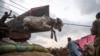 Traders unload a cow from a truck at a cattle market set up for the upcoming Muslim Eid al-Adha festival or the Festival of Sacrifice in Karachi, Pakistan.