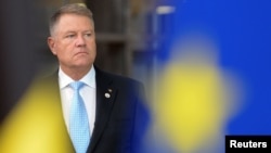 FILE - Romanian President Klaus Iohannis arrives for the second day of the European Union leaders summit dominated by Brexit, in Brussels, Belgium, Oct. 18, 2019. 