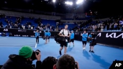 FILE - Andy Murray of Britain leaves the arena on after 4 a.m. Jan. 20, 2023, following his win over Australia's Thanasi Kokkinakis at the Australian Open tennis championships. The Australian Open will begin on a Sunday next year and expand to a 15-day event for the first time. 